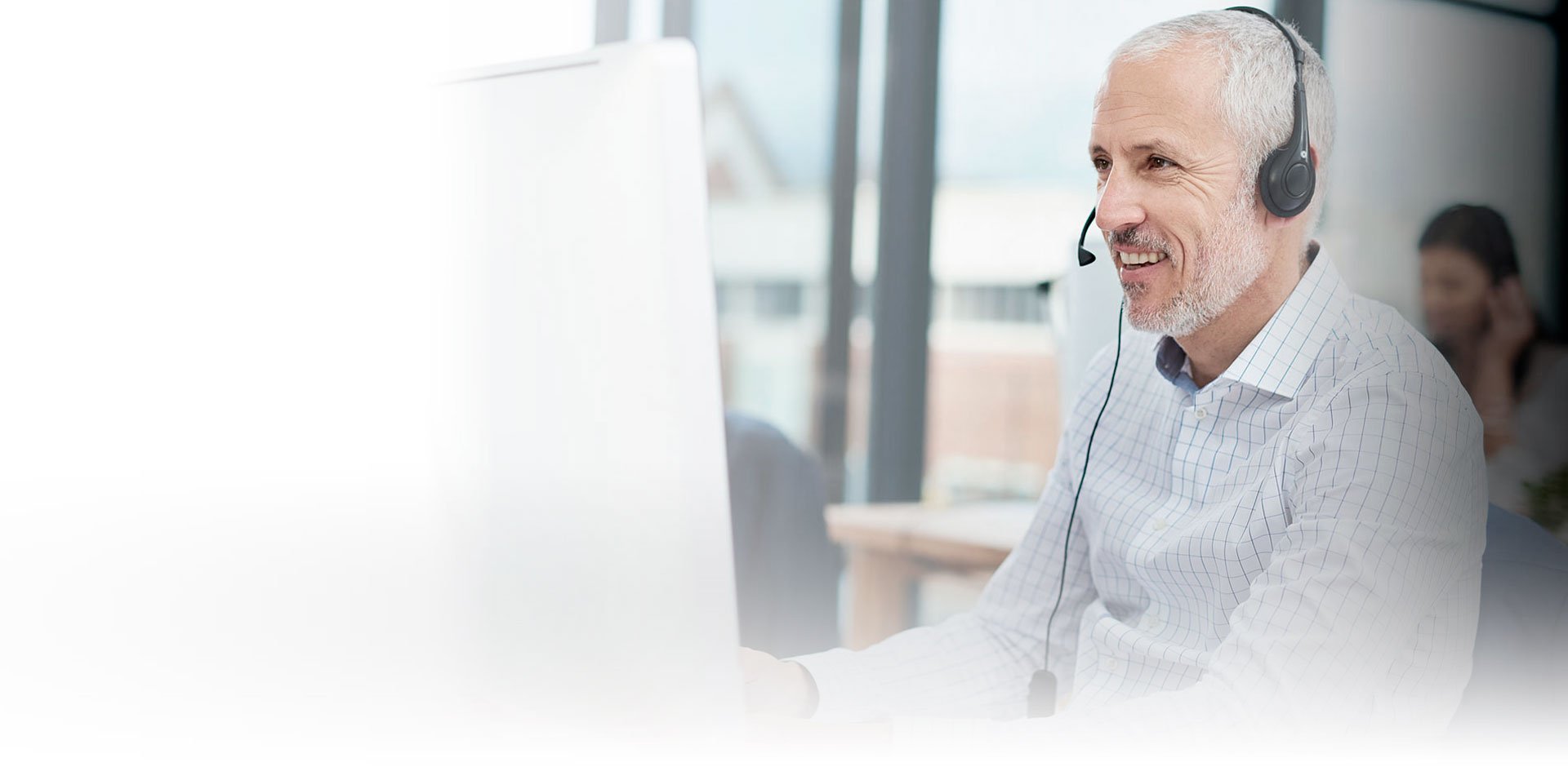 A man from Diatec Diagnostics talking into his headphones, looking into a computer screen
