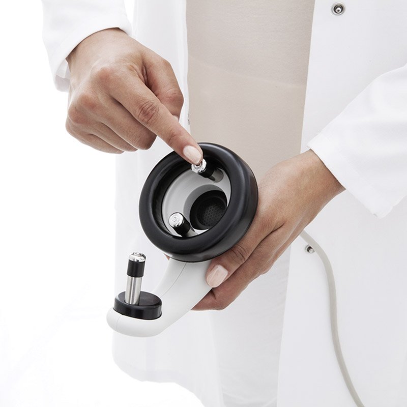 Woman pointing her finger at the earpiece on a MAICO MB 11 BERAphone