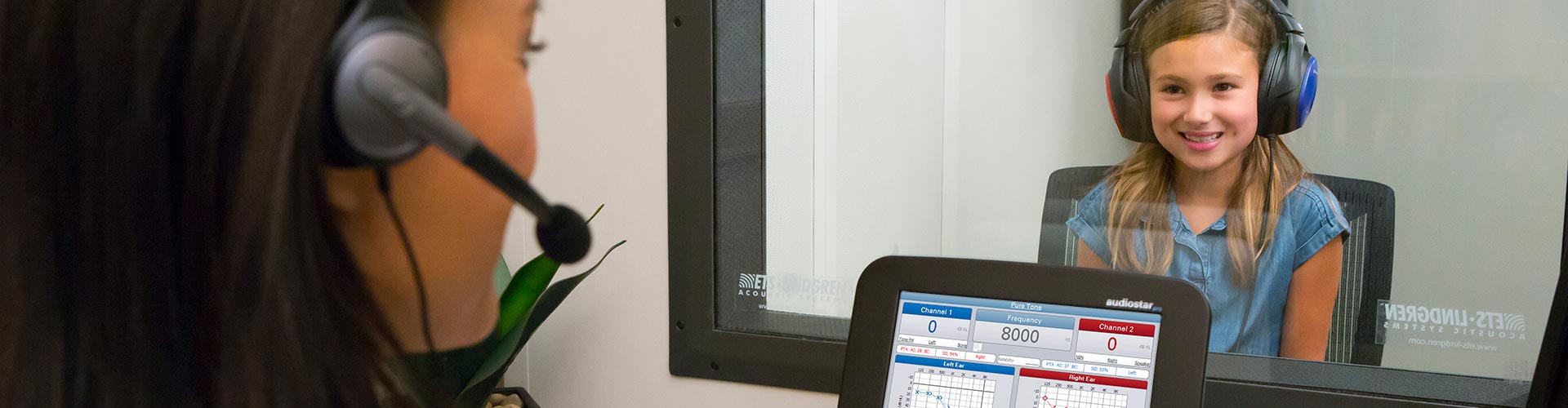 Audiologist performing a hearing test on a child