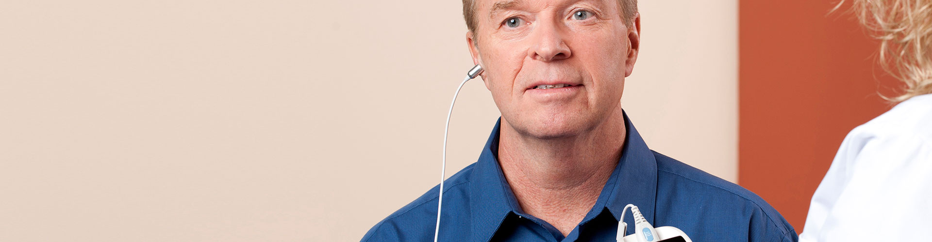 An audiologist testing OAEs on a patient