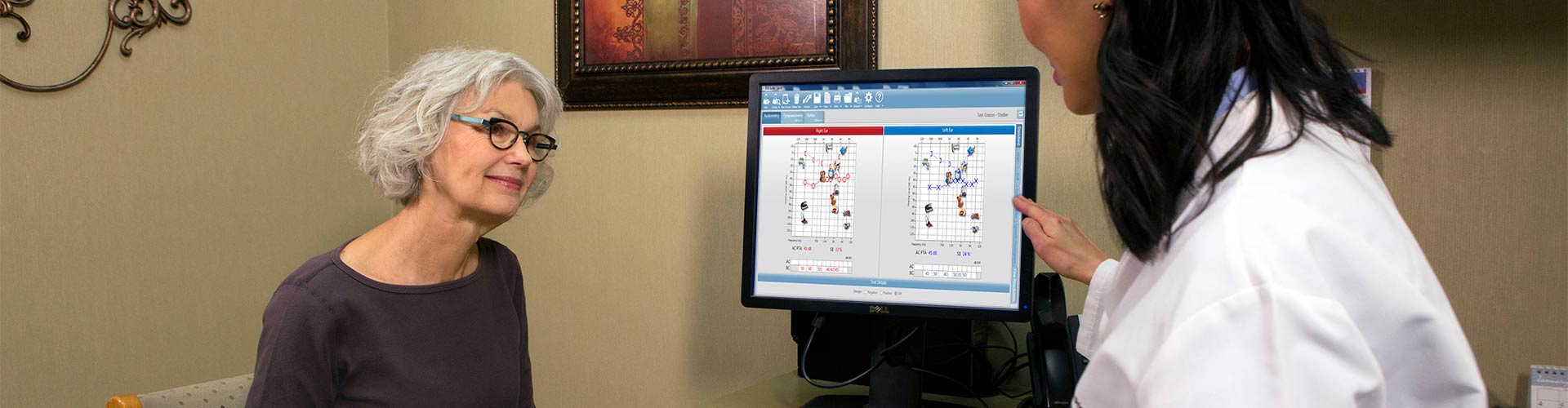 An audiologist counseling a patient on audiometric testing results