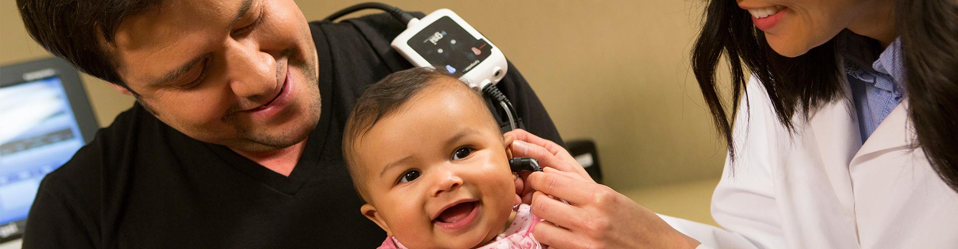 audiologist performing tympanometry testing on an infant