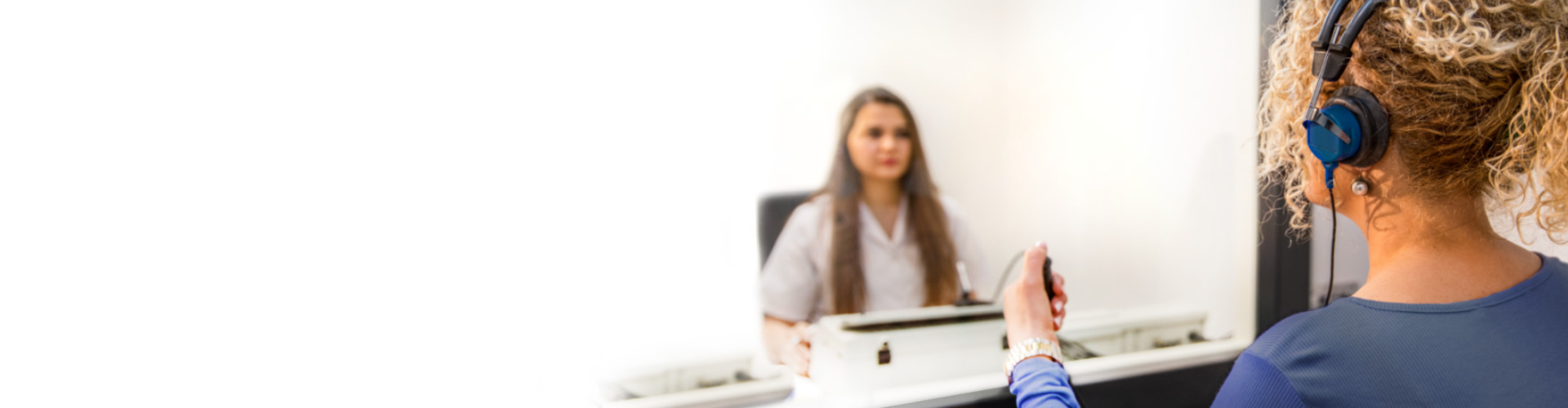 A man at a consultation at a hearing care specialist or an audiologist
