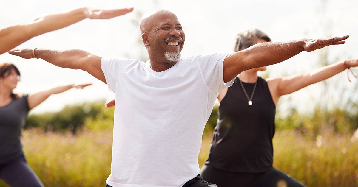 A group of people practicing yoga for mindfulness, a way to relieve tinnitus