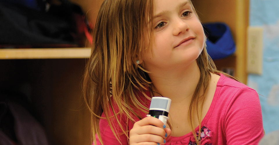 girl-with-mic-and-book-960-x-500