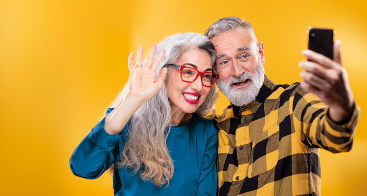 Amigos de mediana edad usando un smartphone para conectar con familia y amigos realizando una llamada.